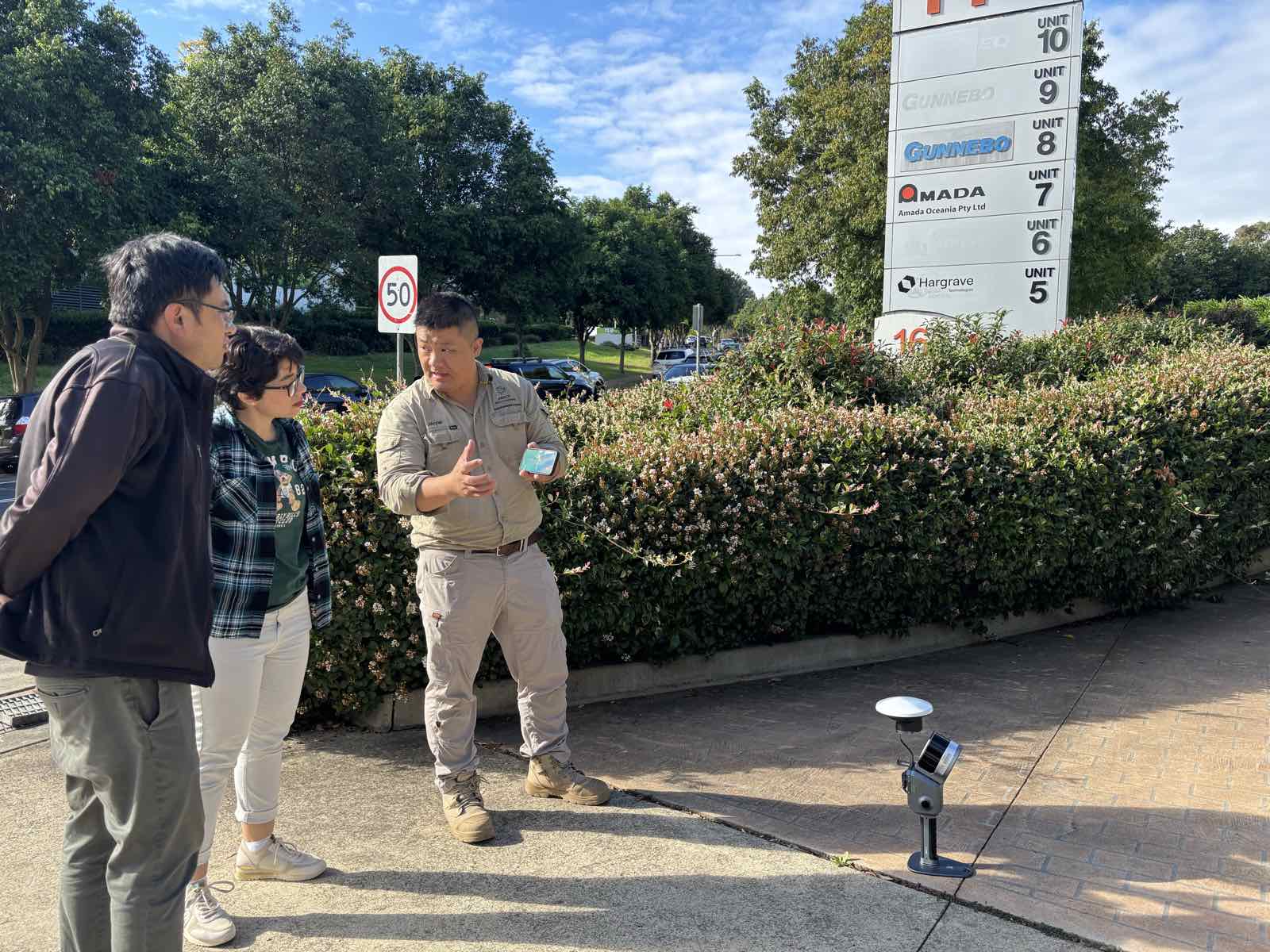 Jacob Lee presenting beside a ground control point marker