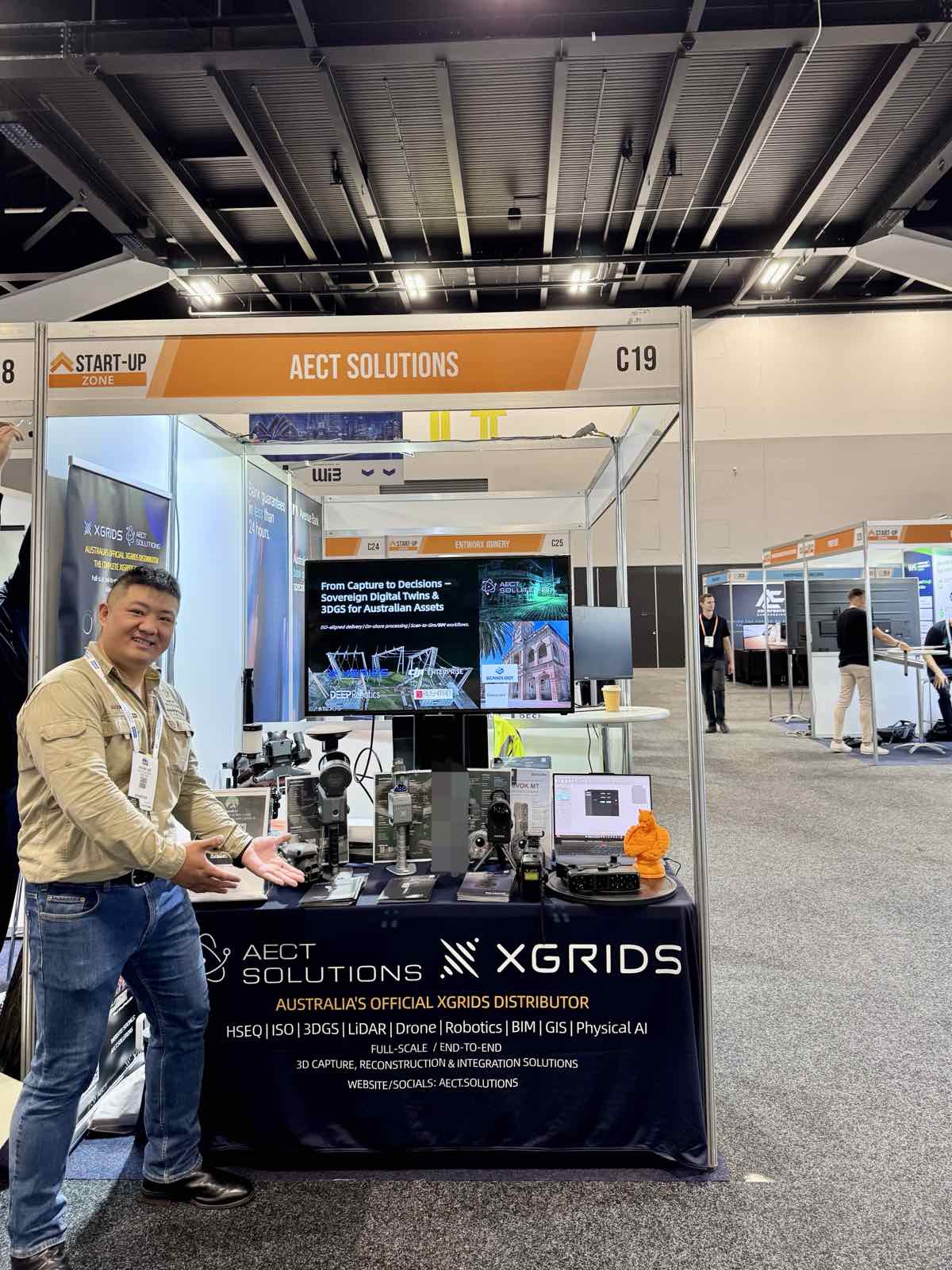 AECT Solutions × XGRIDS product display at a trade show booth
