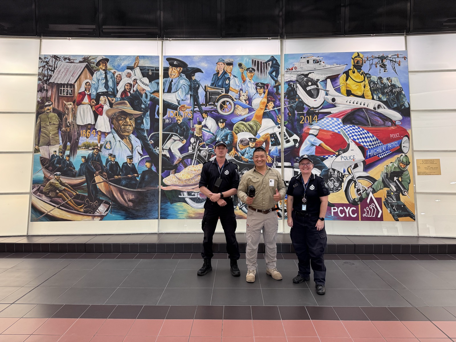 Law-enforcement team scanning a heritage mural indoors