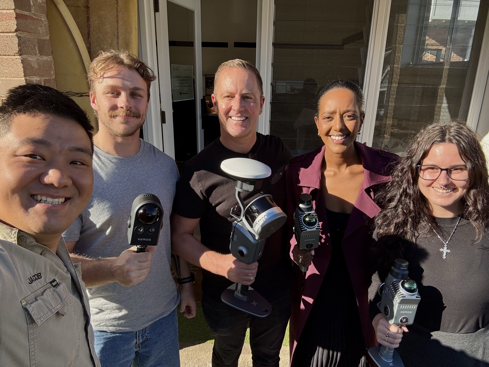 Customer team holding XGRIDS scanners and RTK gear