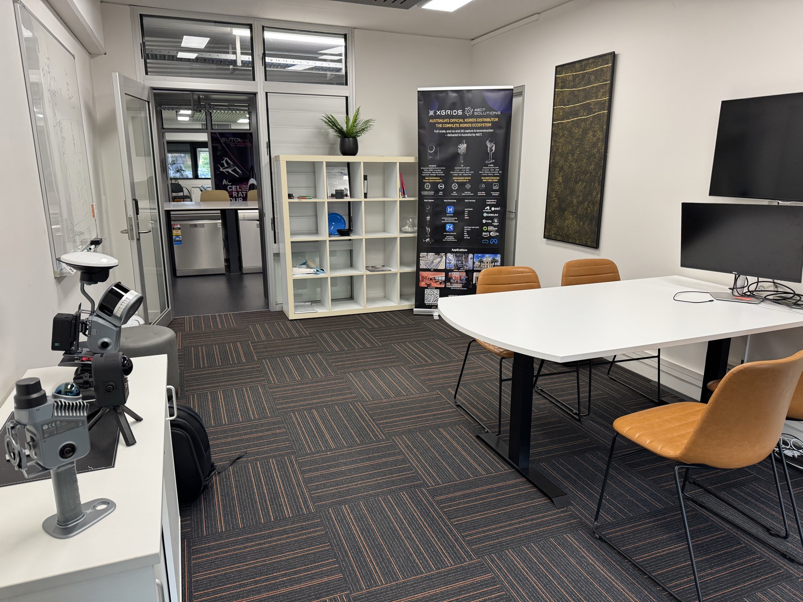 AECT showroom and meeting room with XGRIDS displays